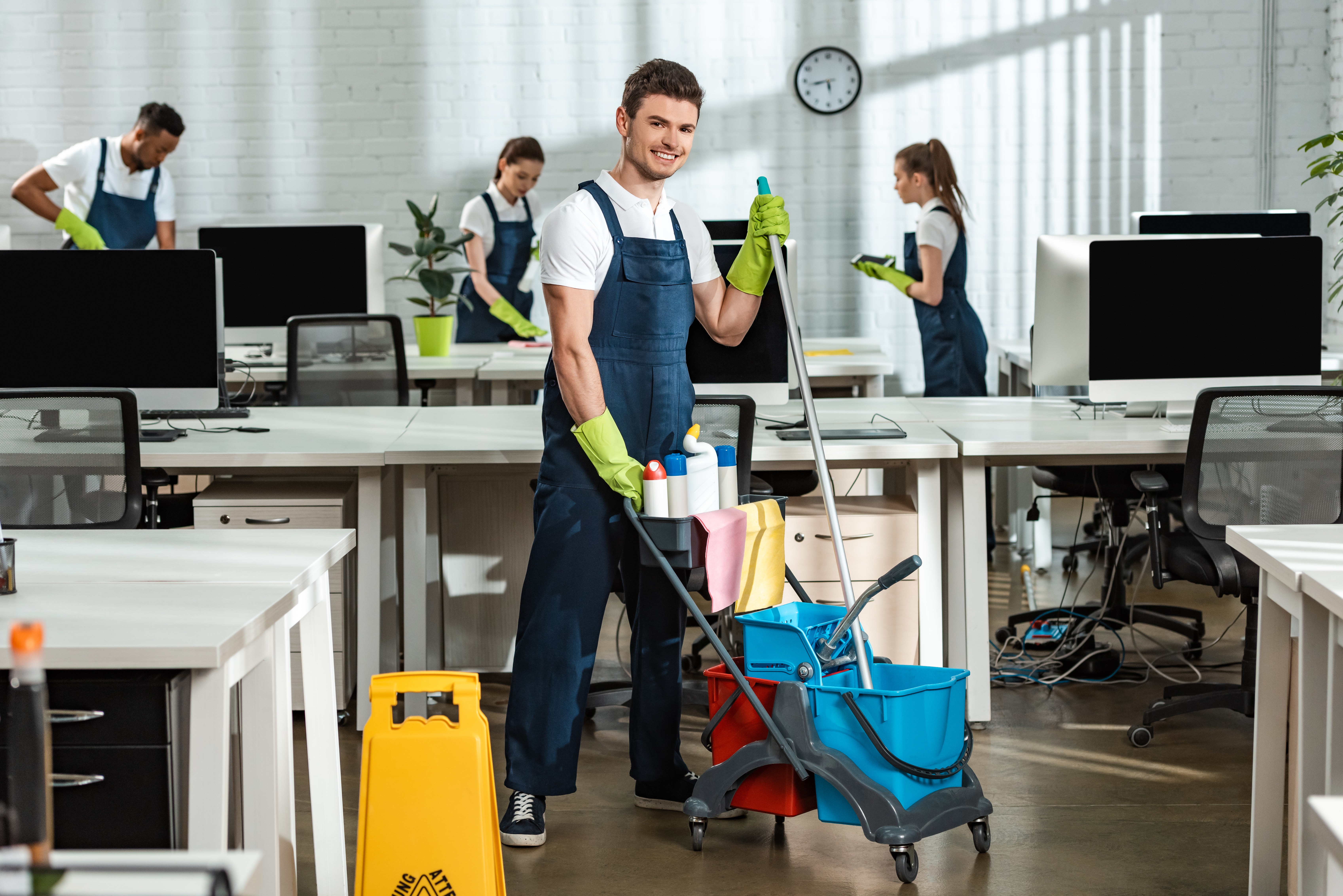 Portrait of man Cleaning an Office using an overall