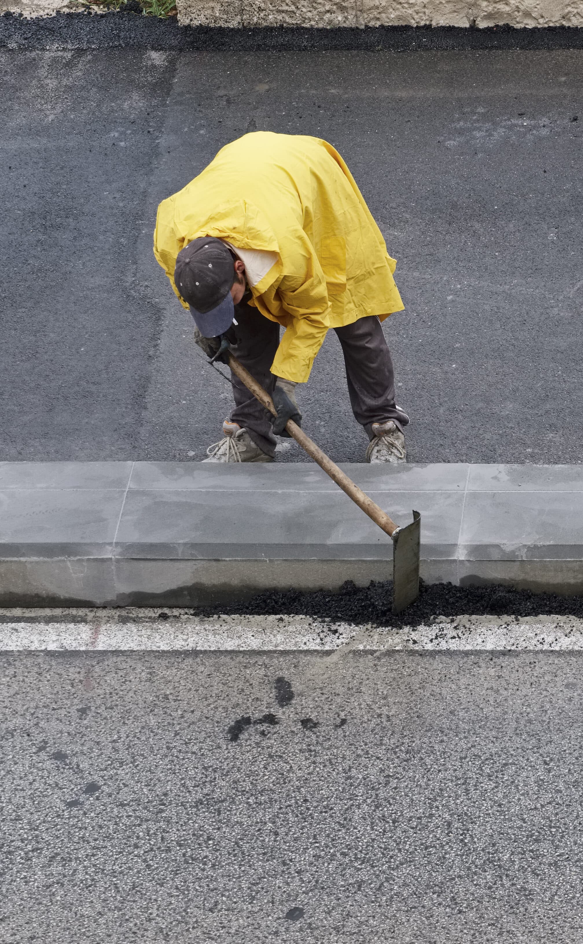 Portrait of a Man working on a Concrete Kerbs in the streets