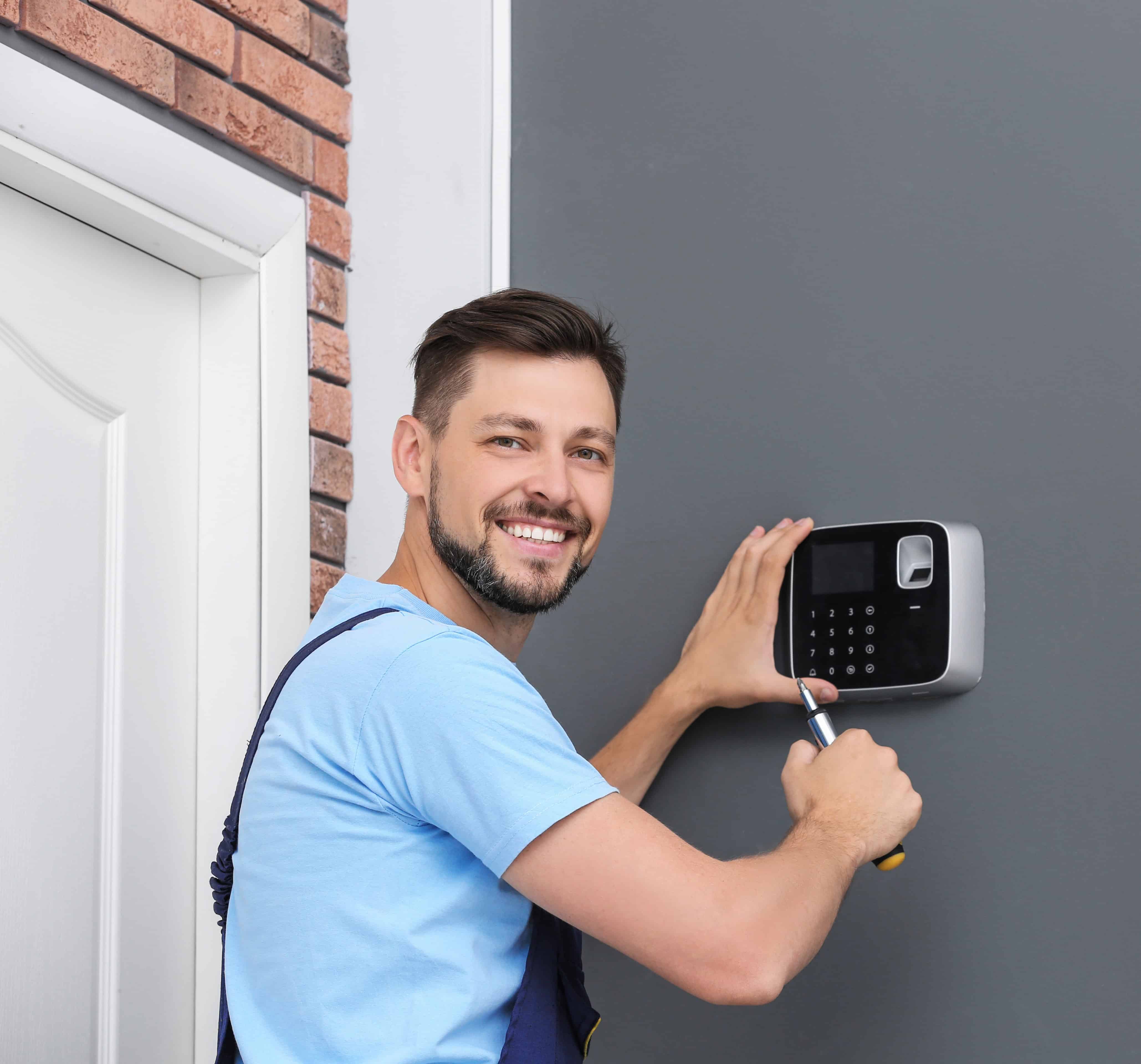 Portrait of a Smiling handyman Alarm System Installation