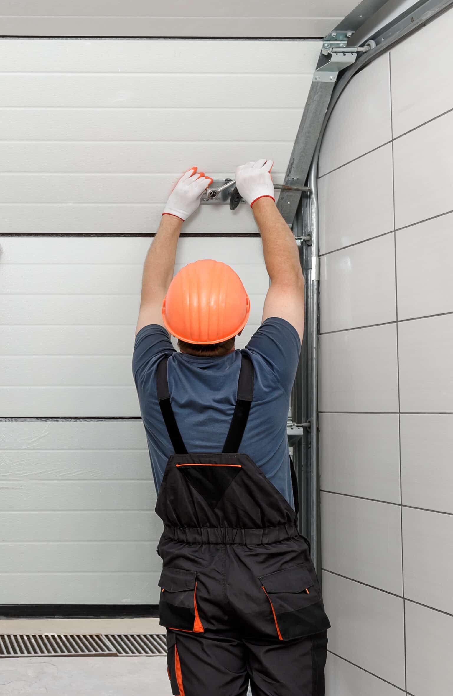 Workers are installing lifting gates of the garage.