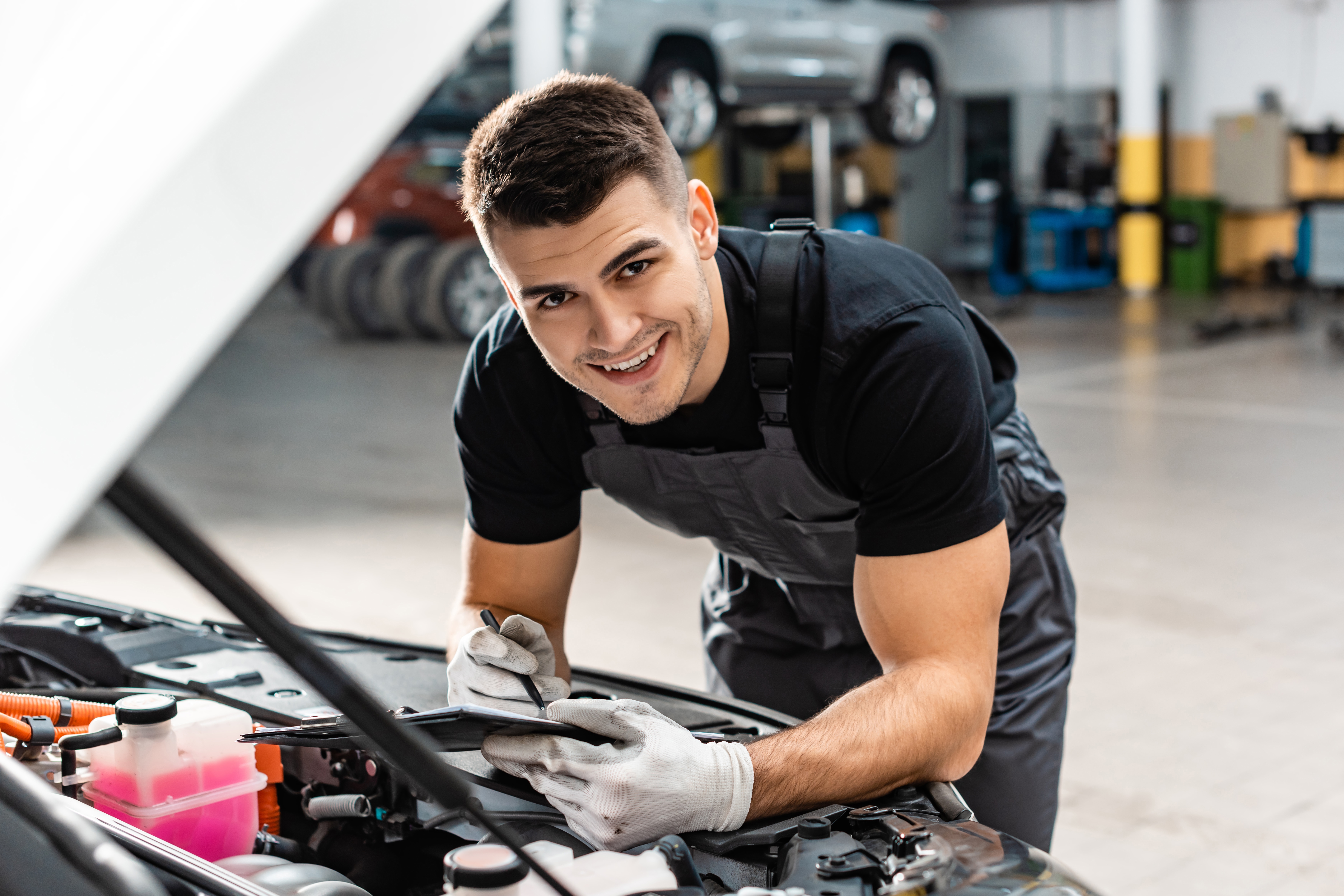 Portrait of Car Pre-Inspection Services in front of car being checked