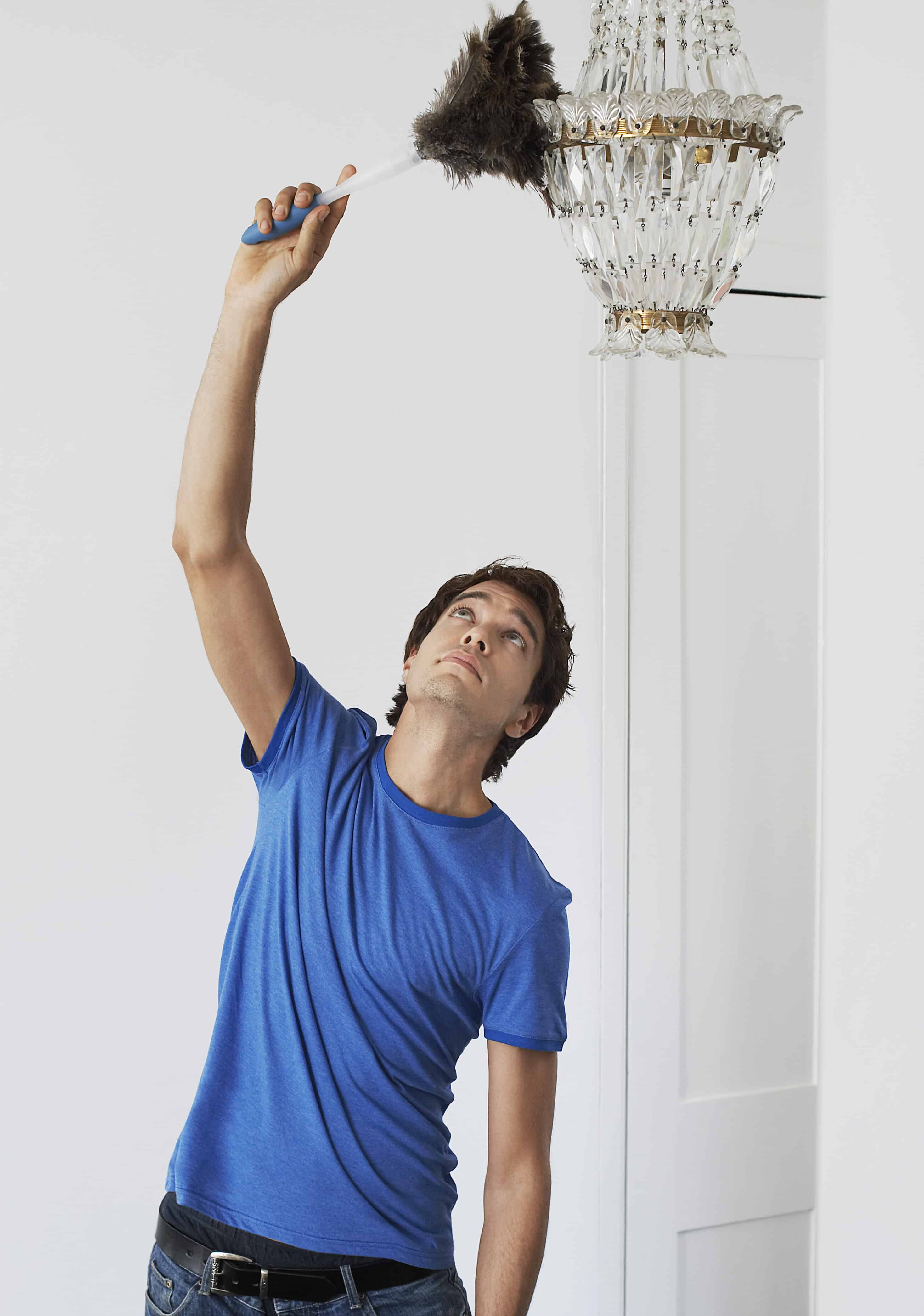 Portrait of a Man dusting crystal chandelier