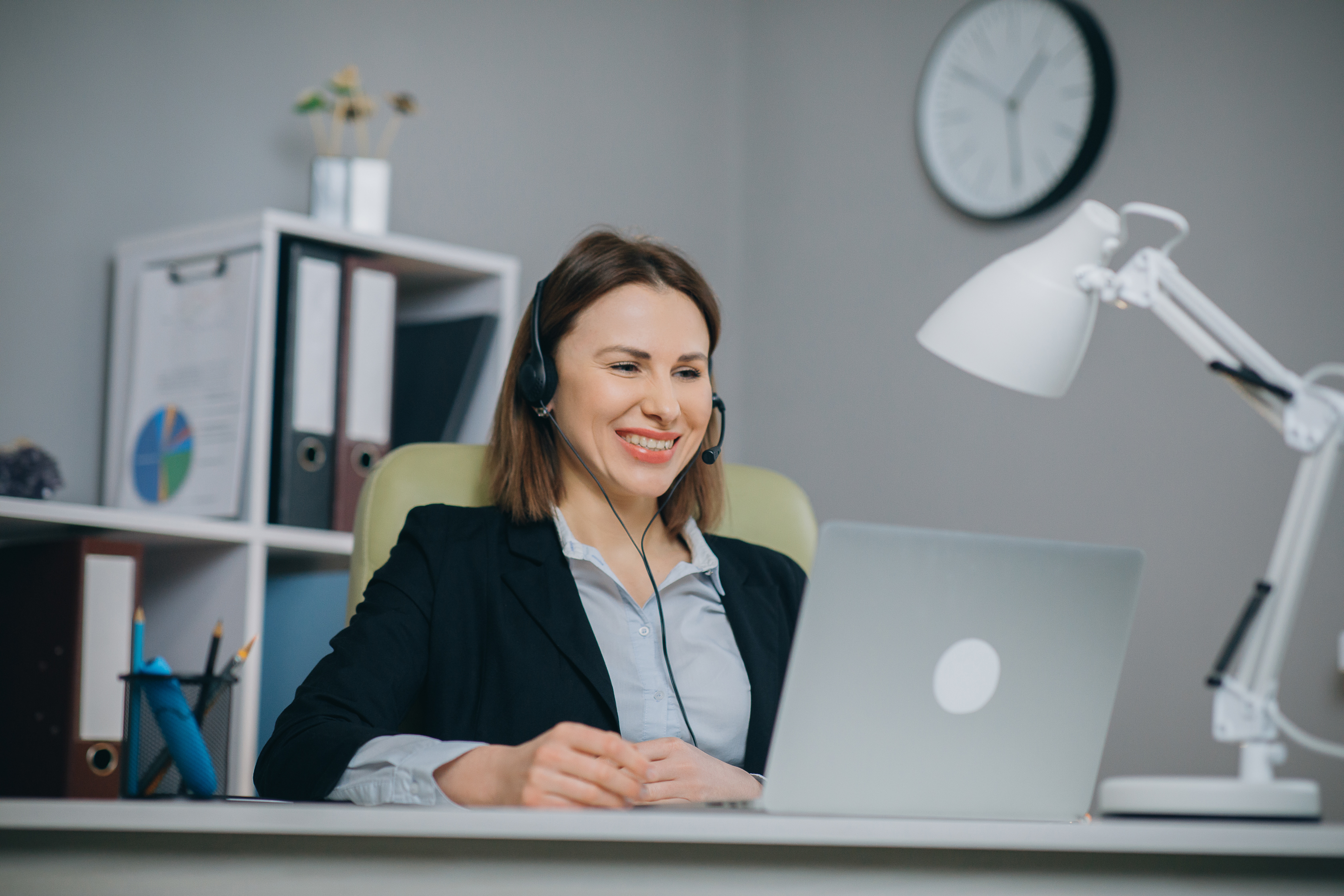 Happy woman in headphones speaking by webcam at webinar training look at laptop, businesswoman talking by video conference call, online teacher teaching consulting client e-coaching concept, Virtual Assistant