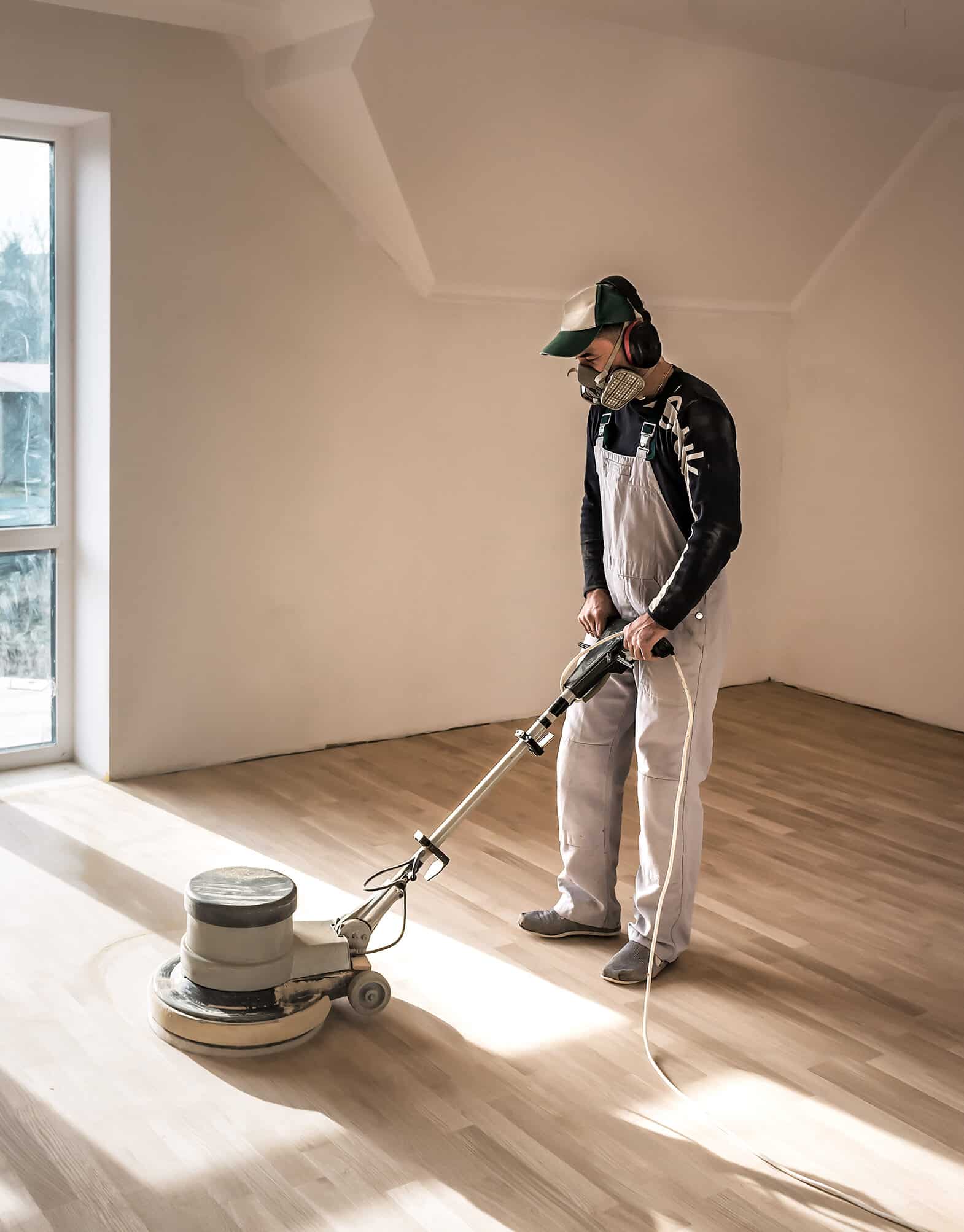 Man (master ) clean the parquet with special polishing machine