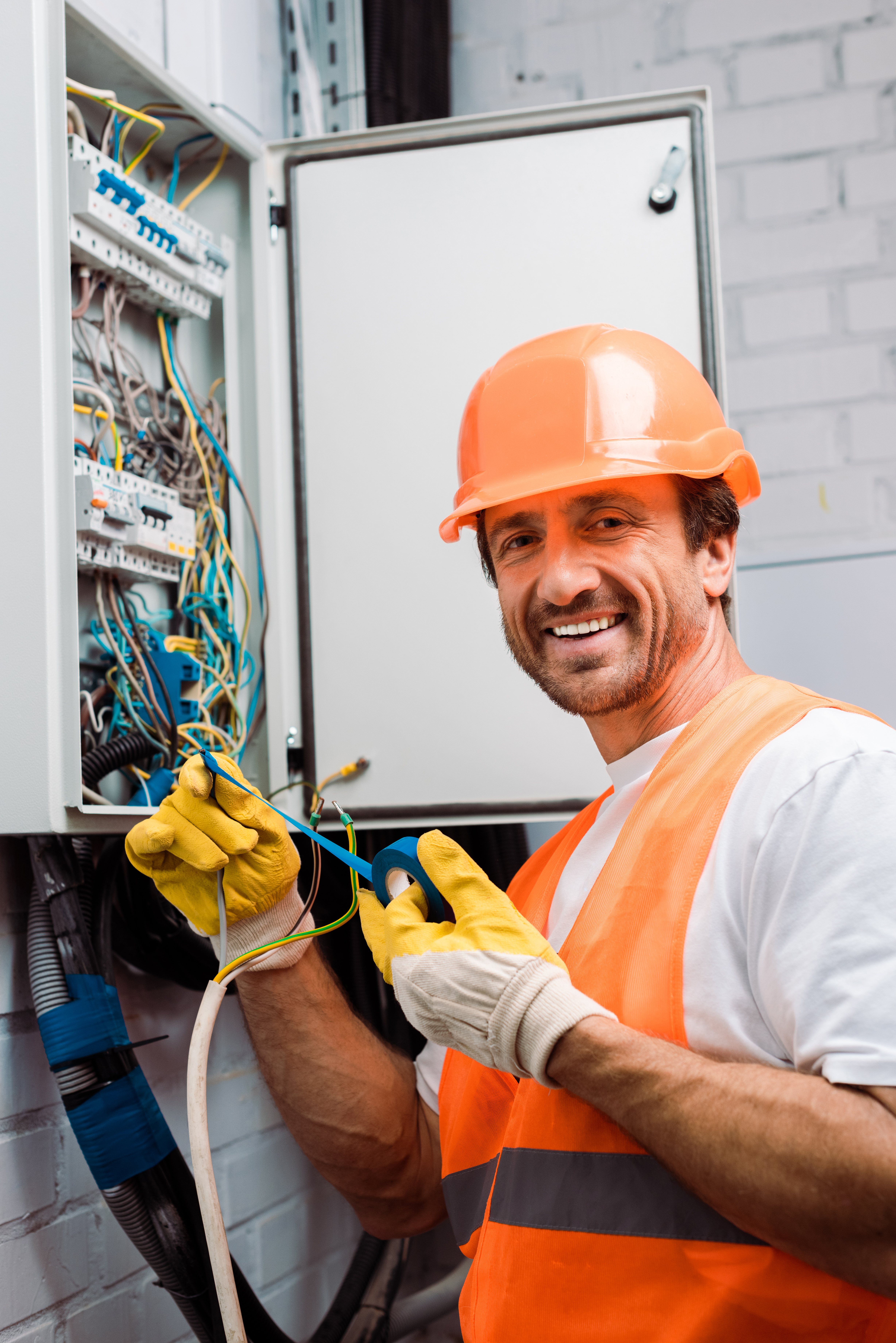 Portrair of an electrician man working on an electrical box