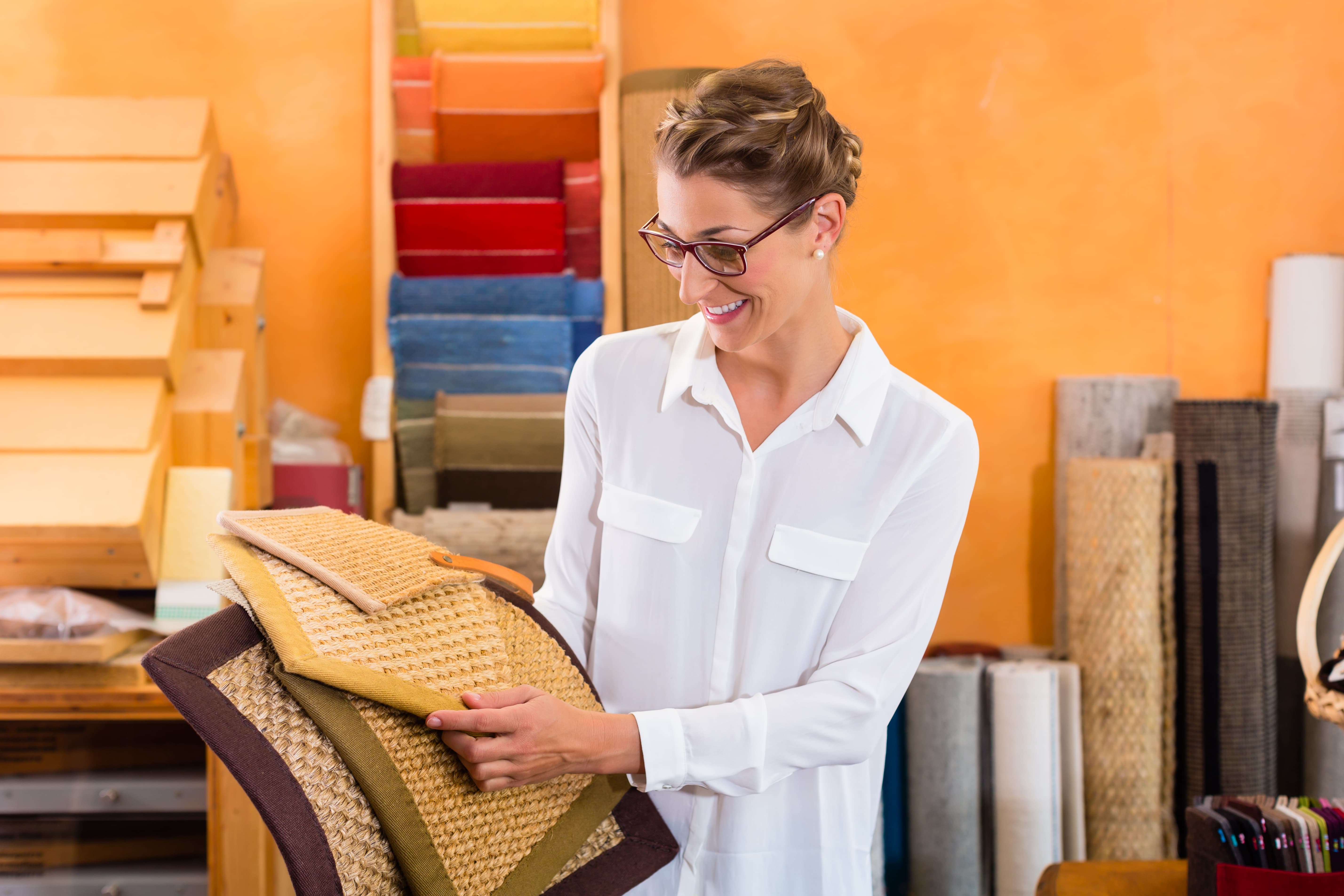 Portrait of a Shopfitter Woman buying floor mats in home improvement store