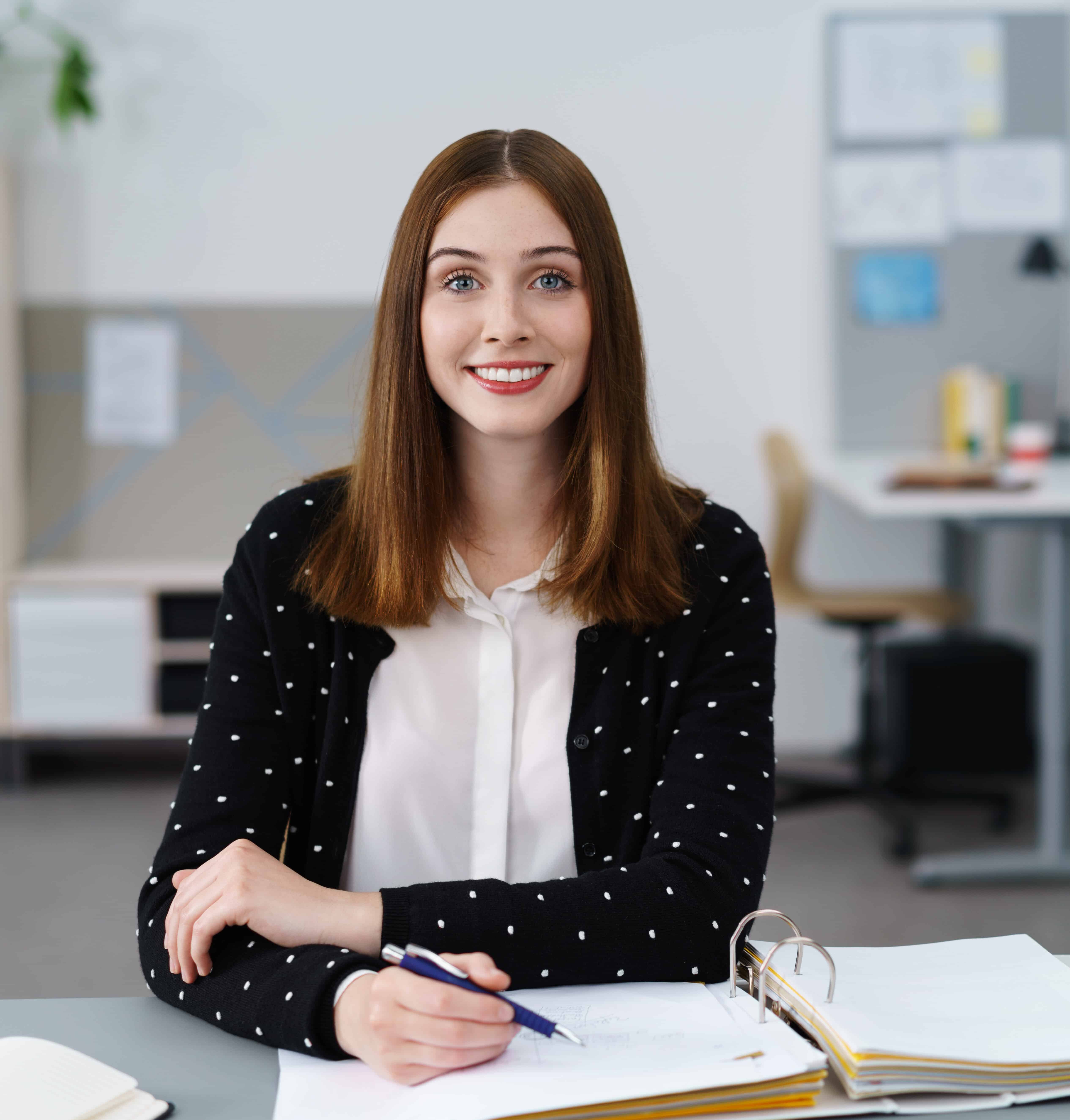 young Personal Assistant working and smiling at the camera