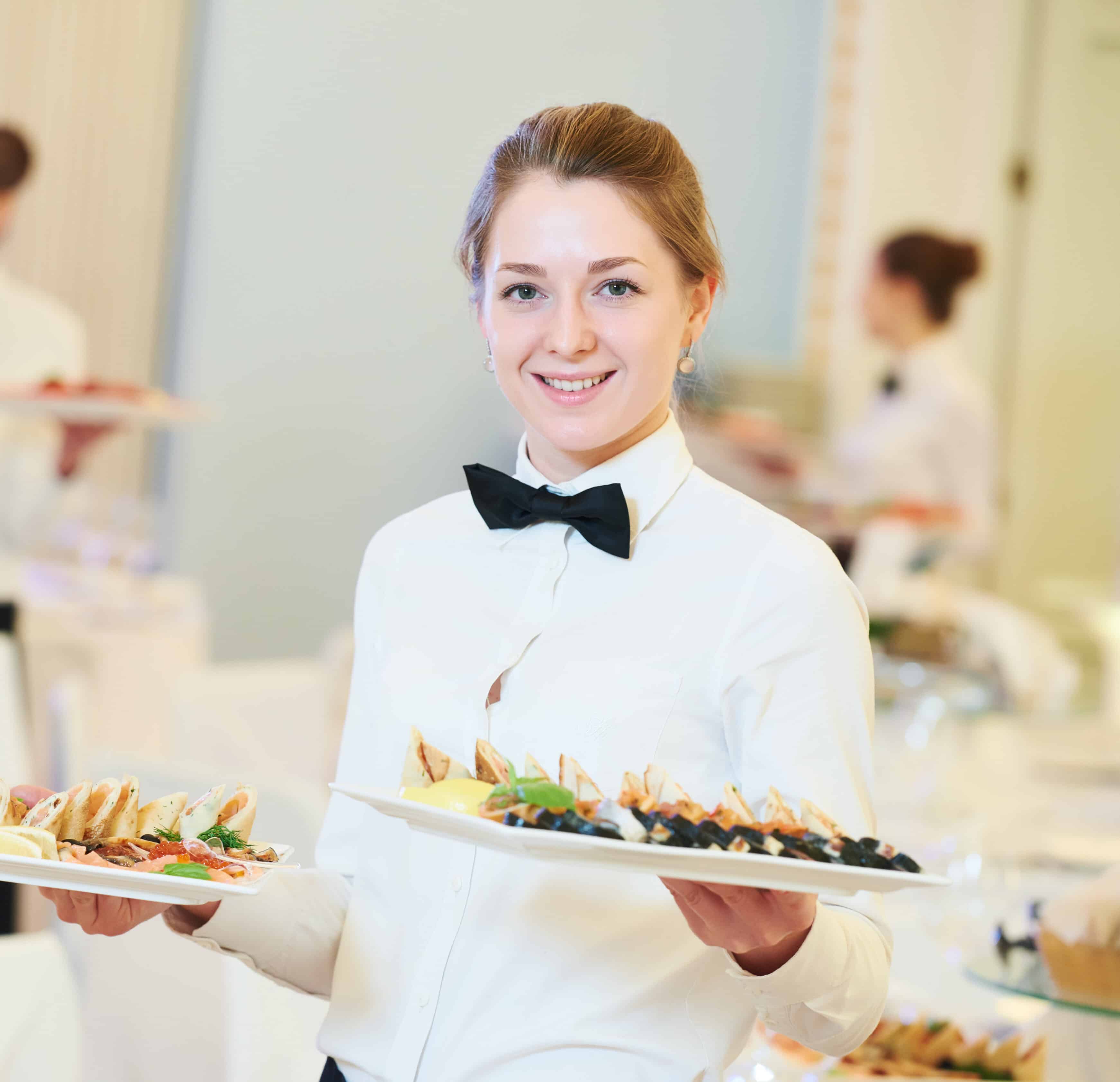 waitress occupation. Young woman with food on dishes servicing during catering of a wedding