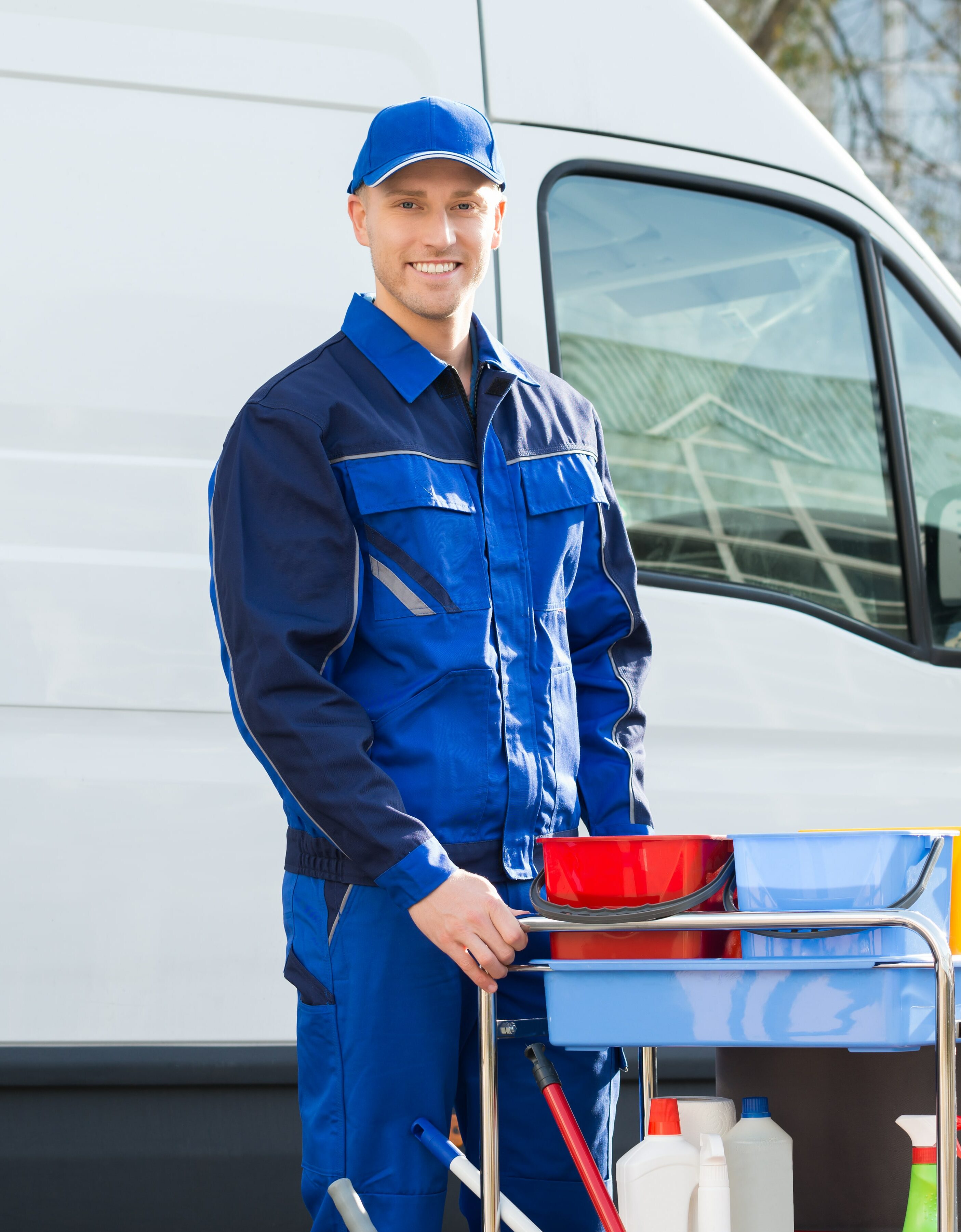Portrait of a Industrial Cleaner Man standing with cleaning equipment against truck
