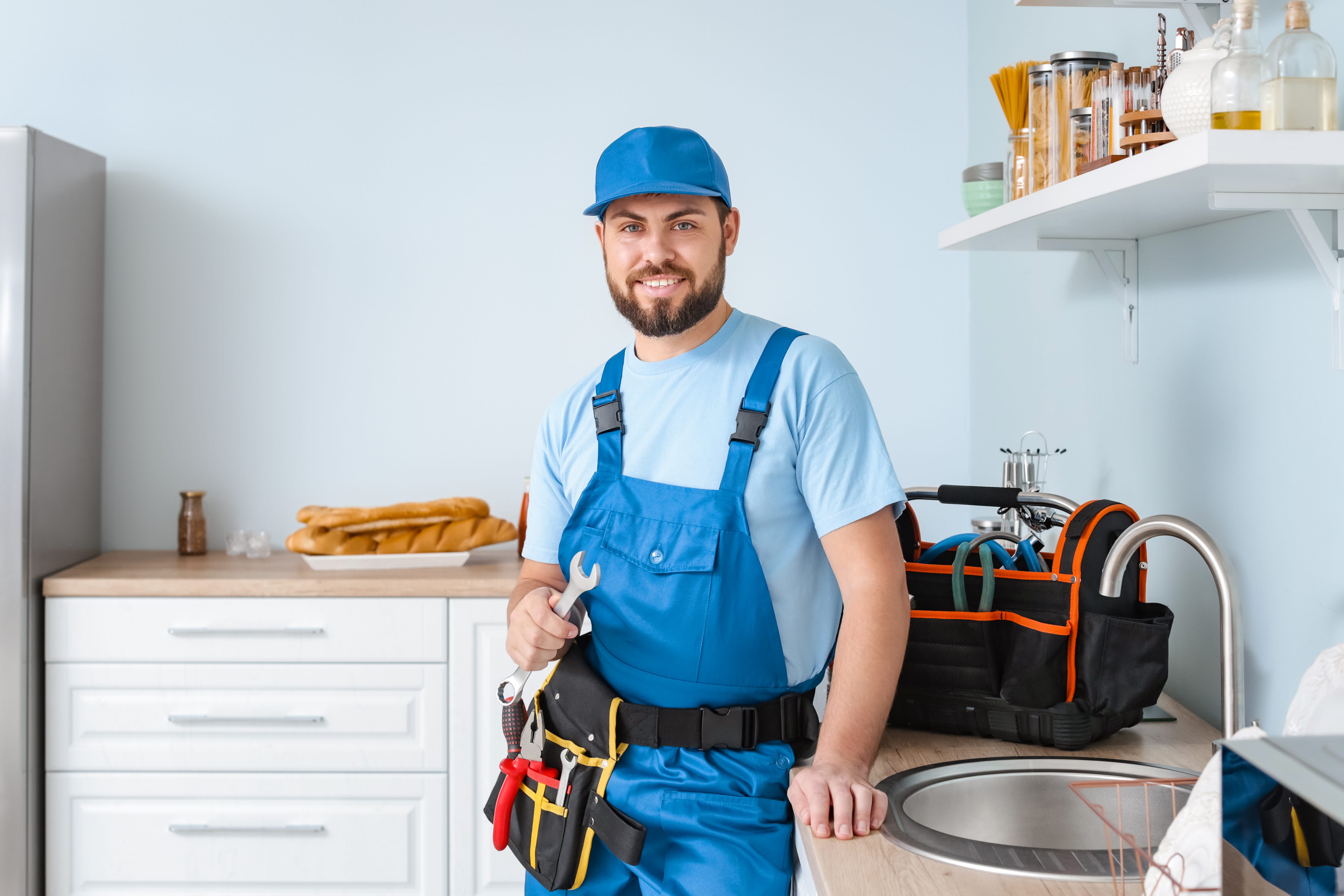 Portrait of plumber in front of kitchen