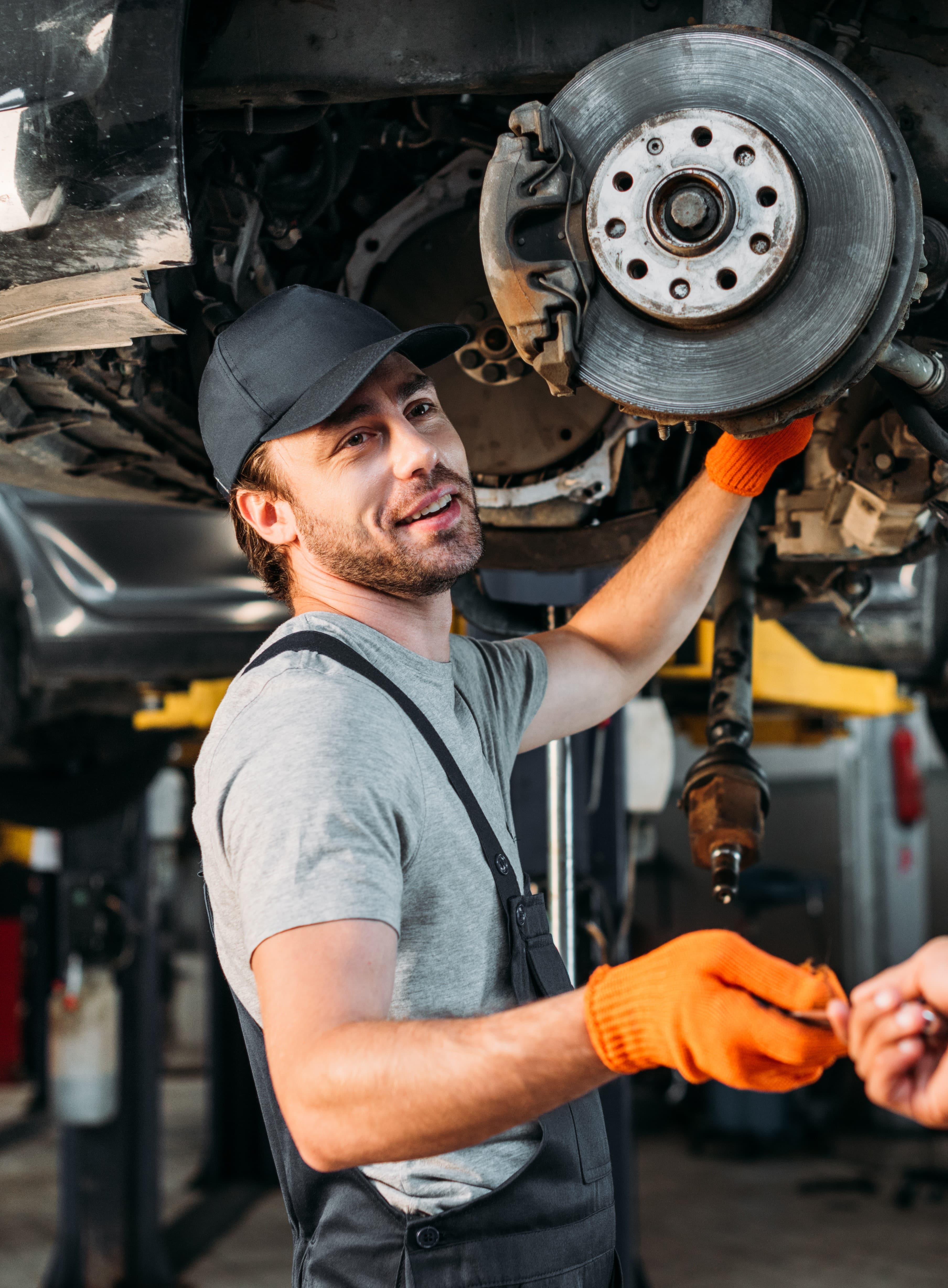 Portrait of a Smash Repair Man wearing an overall next to a car