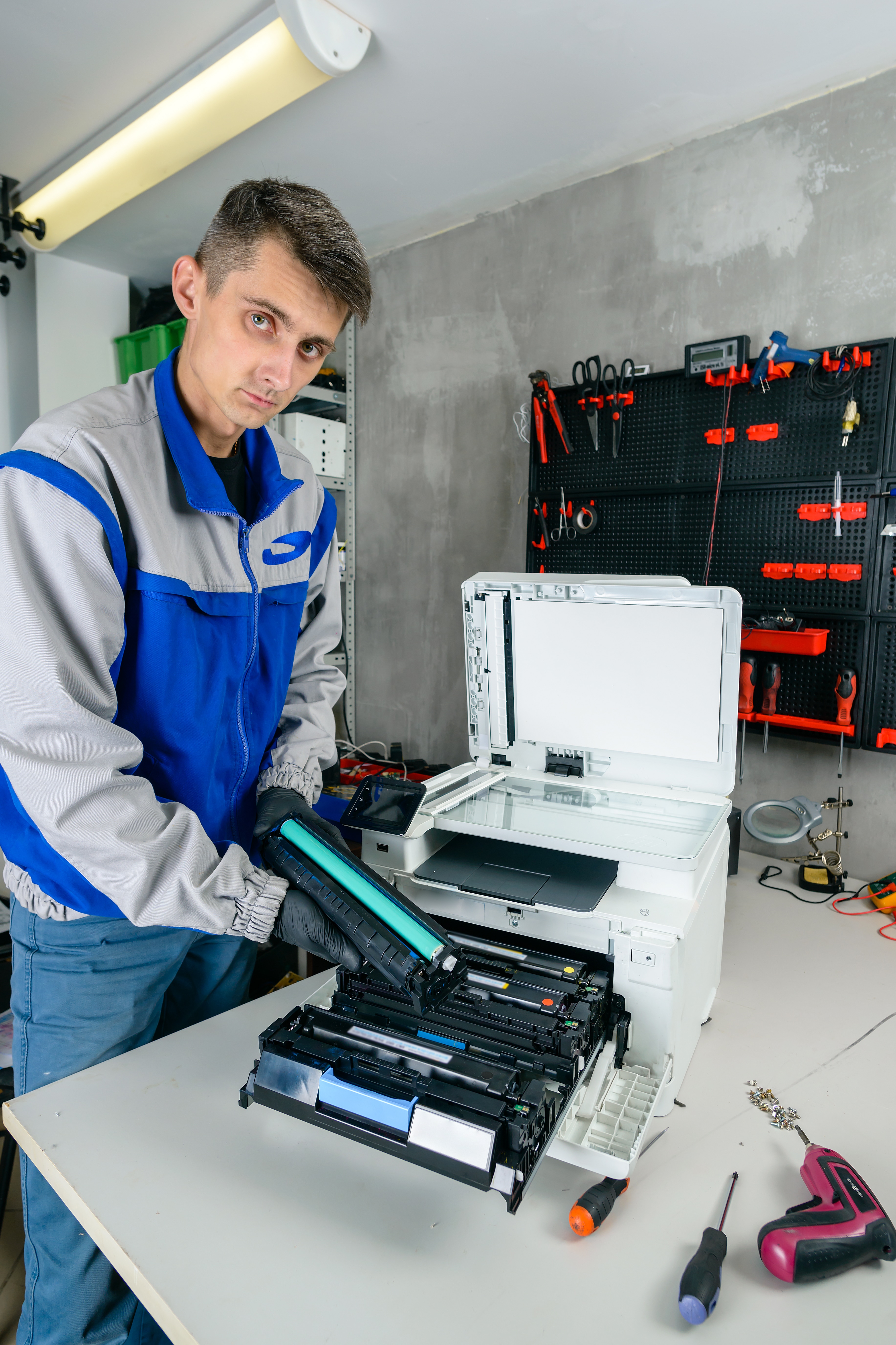 master professional Printer Repairs in the workshop. specialist repairman serves or repairs the laser printer