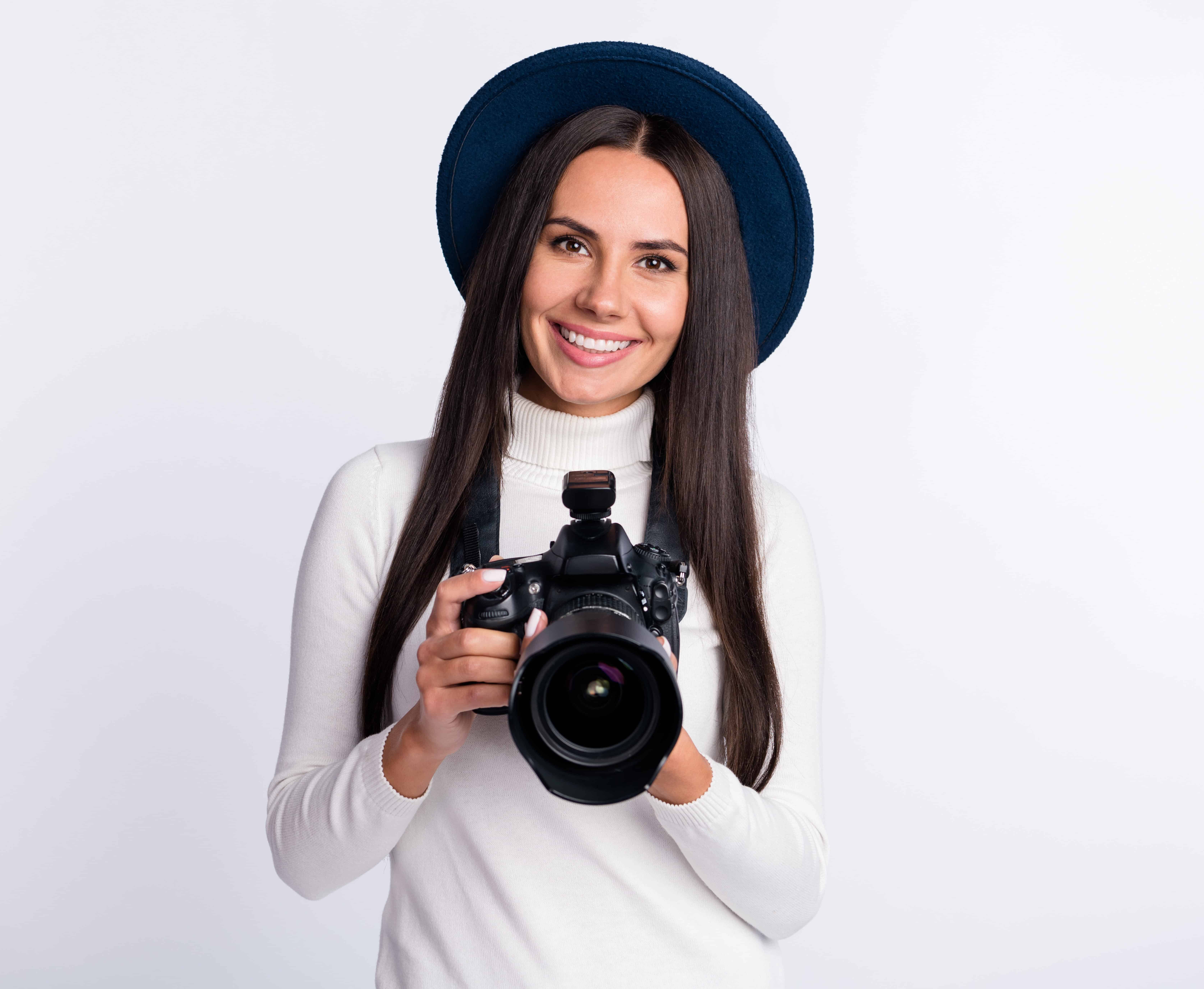 Photo of attractive young happy lady photographer smile good mood wear hat isolated on grey color background.