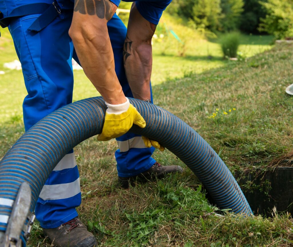 Emptying household septic tank. Cleaning sludge from septic system.