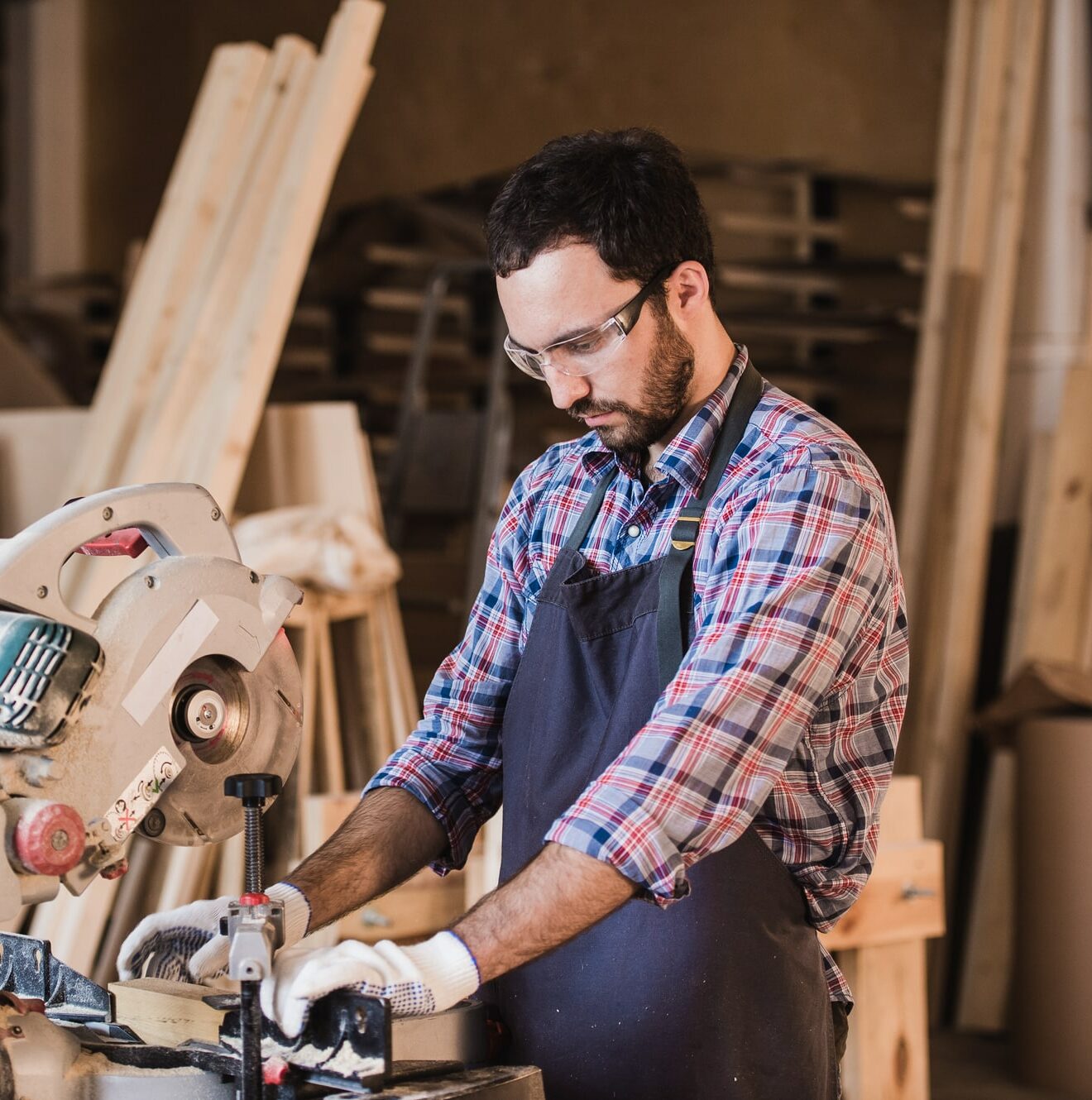 Boat Carpenter using a circular cut off saw to trim wood studs to length