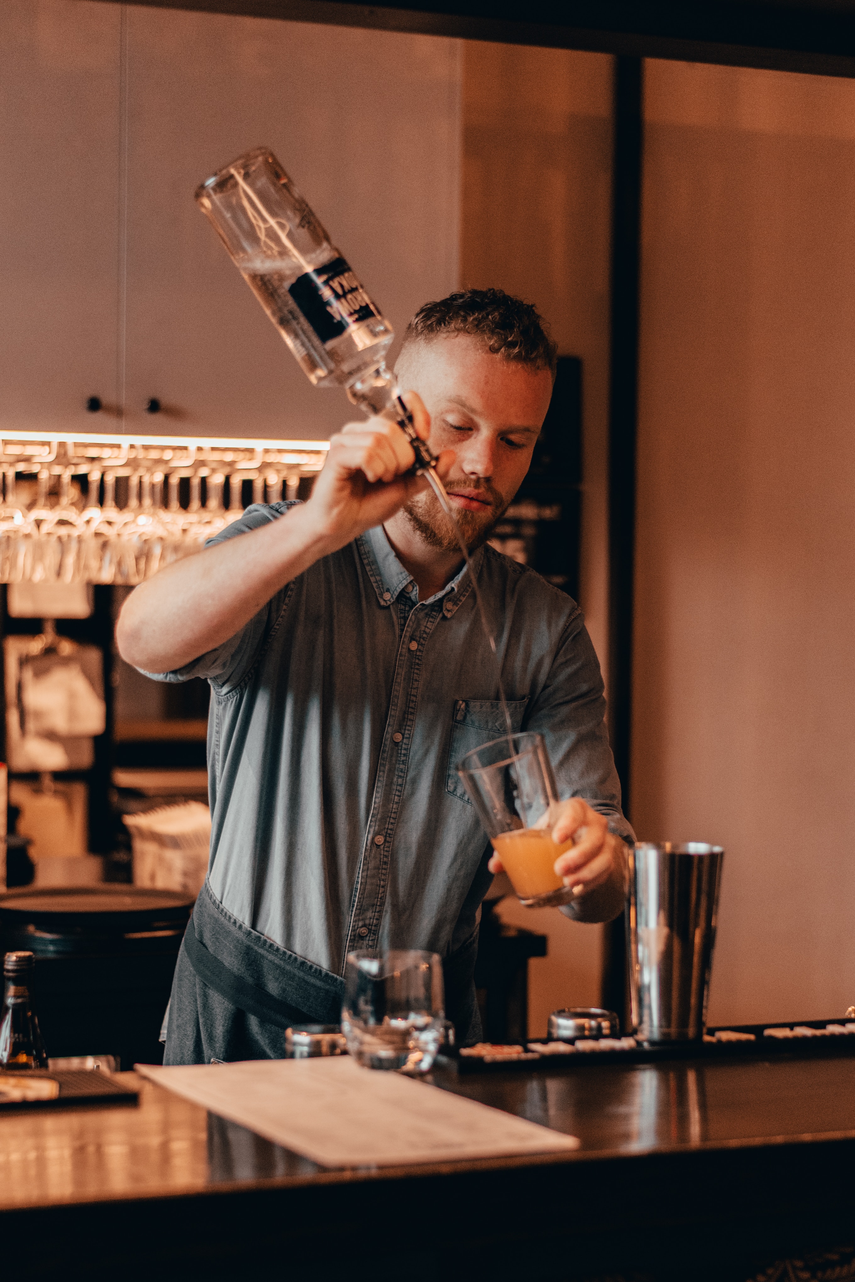 Portrait of a Bar Man doing a drink