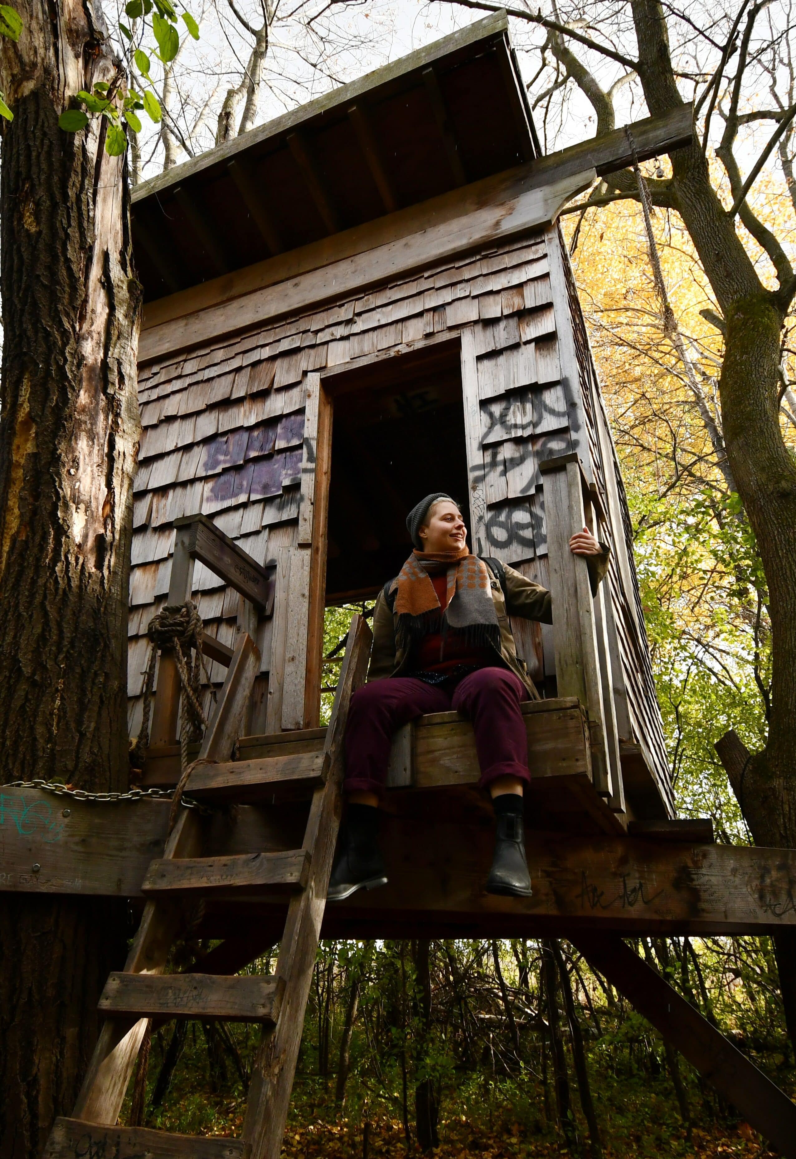 Portrait of a Woman sitting in a Treehouse
